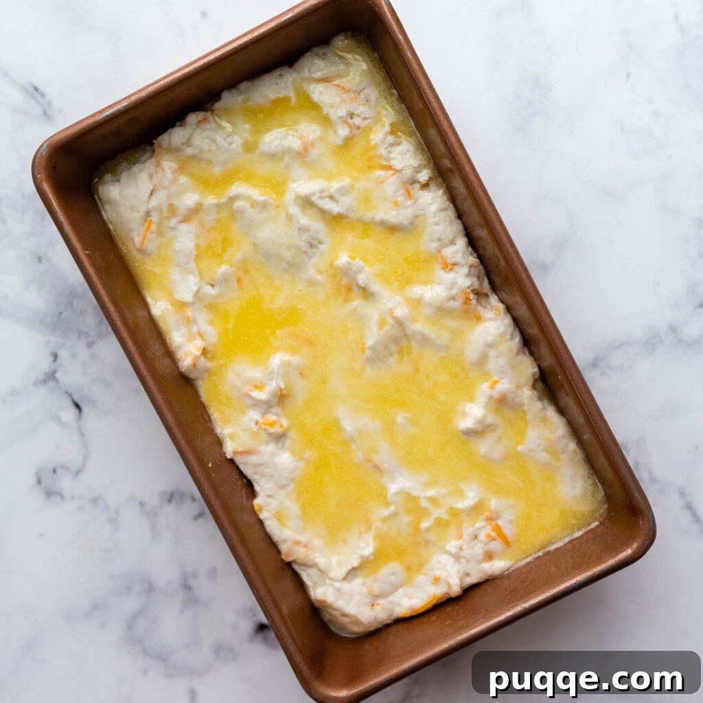 Quick Cheesy Gluten Free Beer Bread 5 gluten free beer bread dough unbaked in a loaf pan.