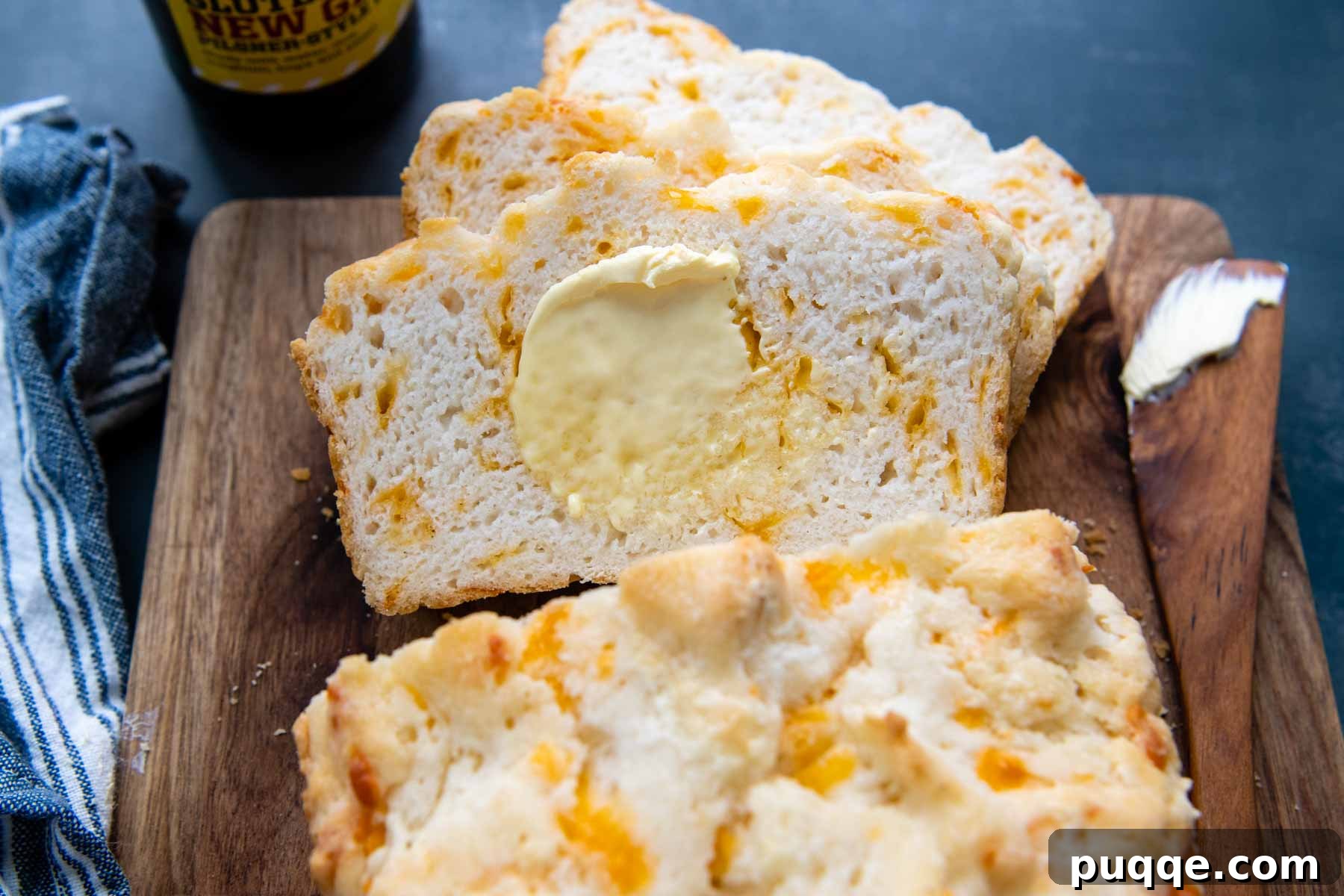 Quick Cheesy Gluten Free Beer Bread 7 sliced beer bread with melting butter spread on.