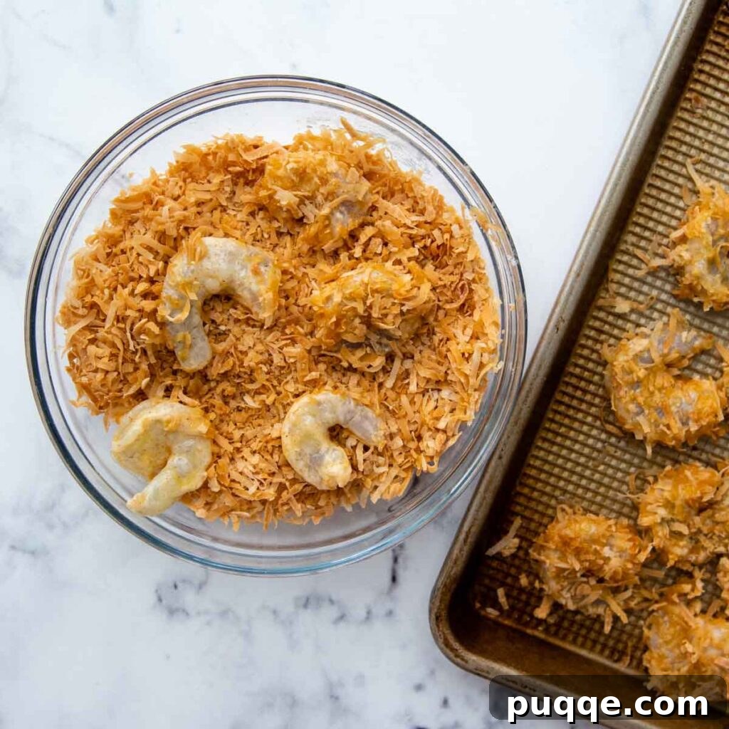 Golden Guilt-Free Coconut Shrimp: Oven or Air Fryer Crisp 4 Shrimp being dipped into toasted coconut flakes during the breading process.