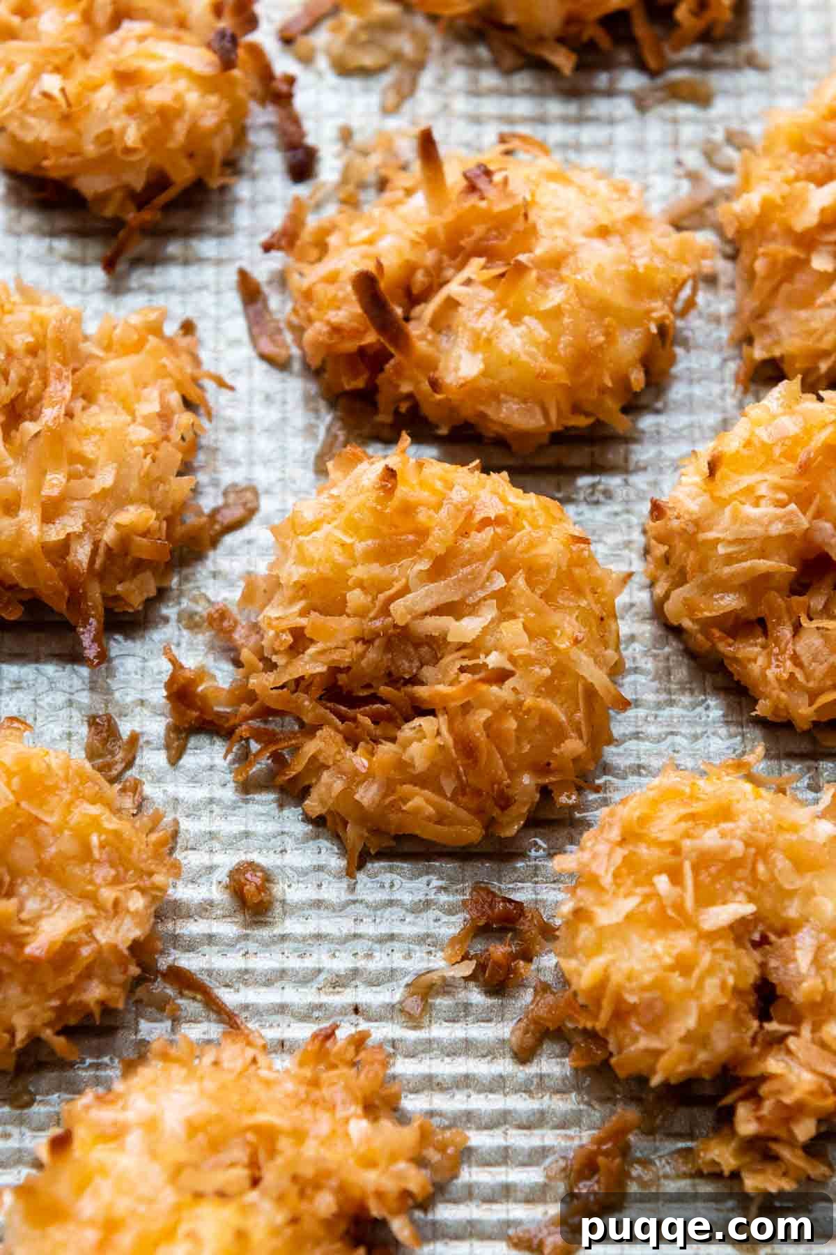 Golden Guilt-Free Coconut Shrimp: Oven or Air Fryer Crisp 7 Gluten-free coconut shrimp arranged neatly on a baking sheet, ready to be cooked.