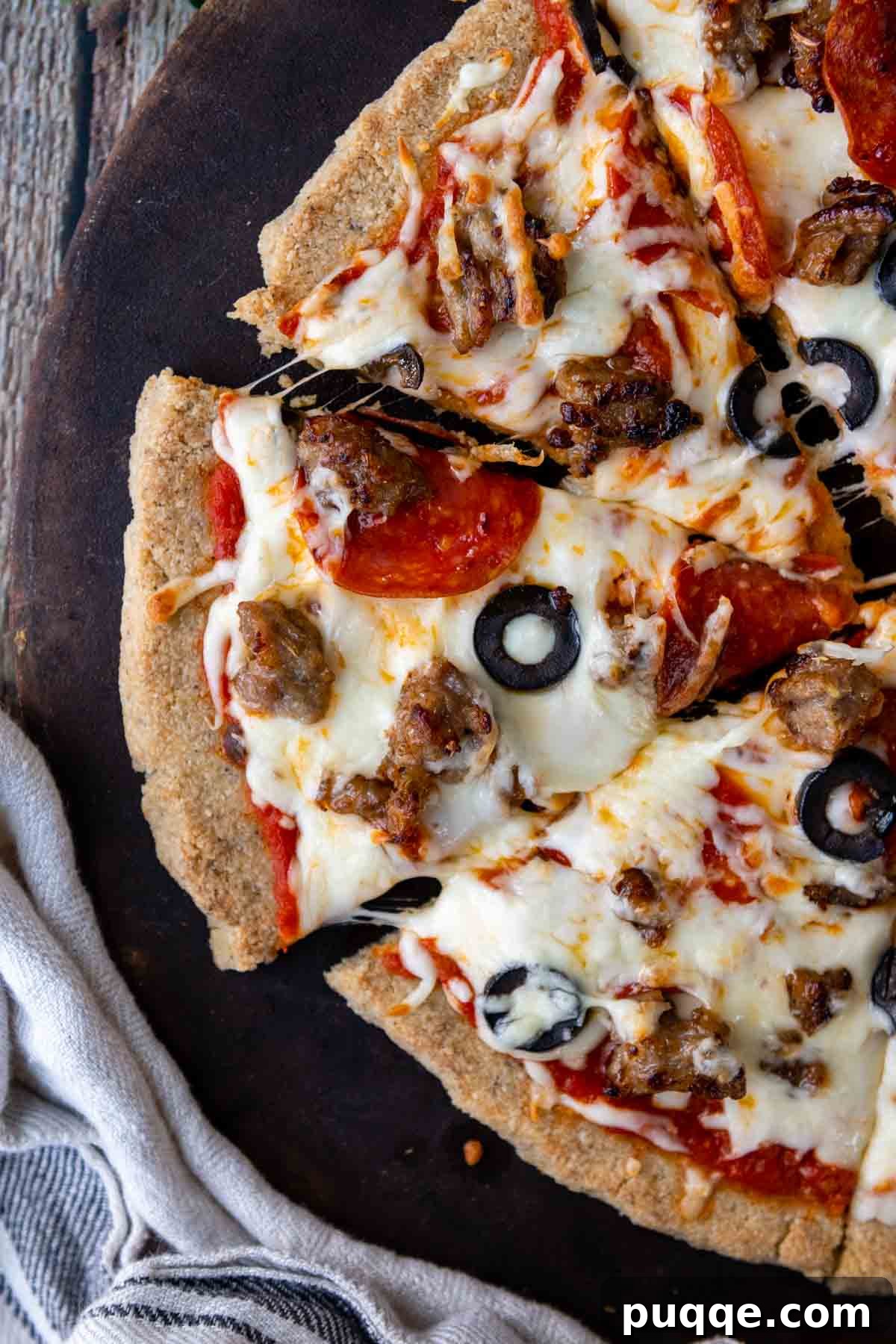 Overhead shot of a delicious almond flour pizza, sliced and ready to be served.