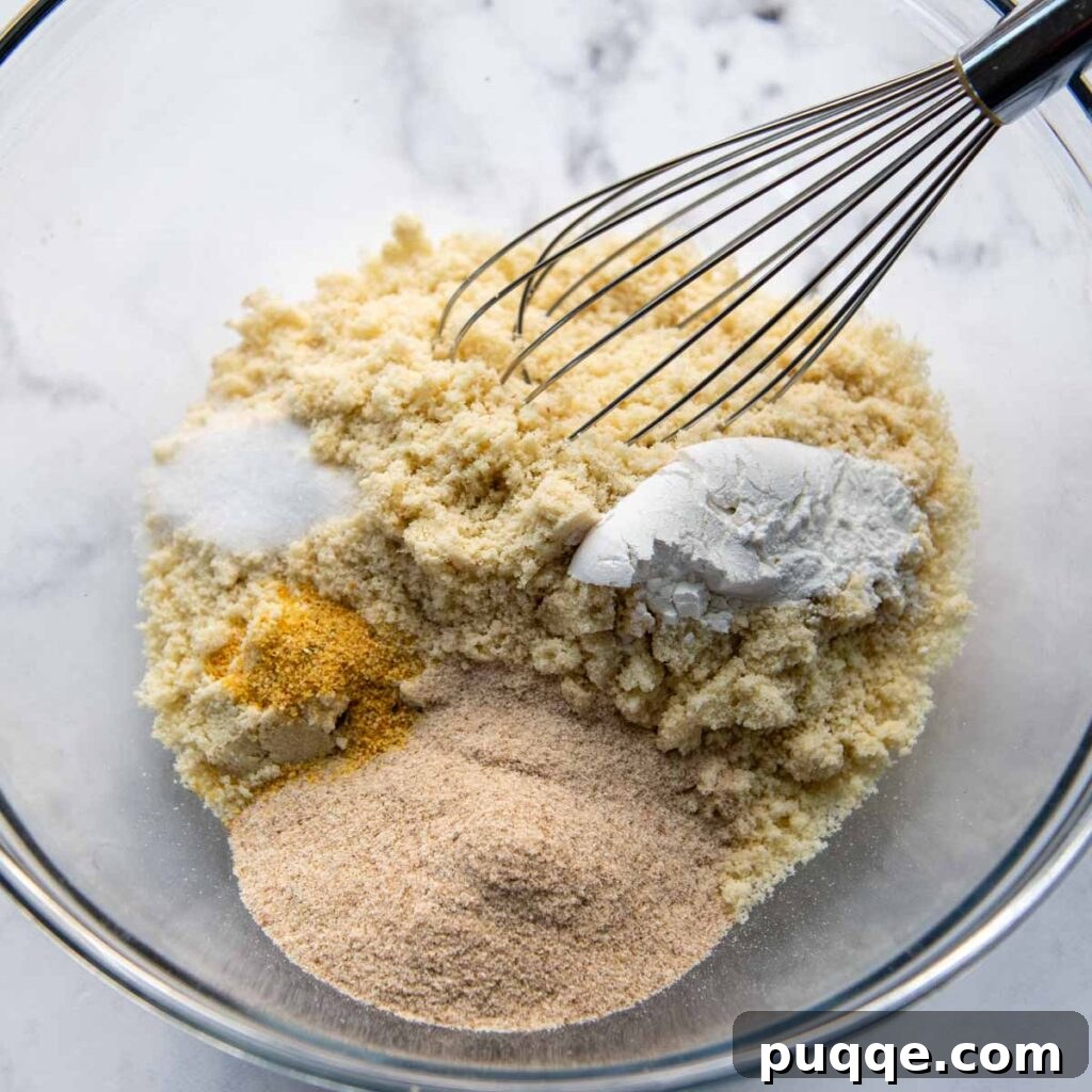 Dry ingredients being whisked together in a mixing bowl.