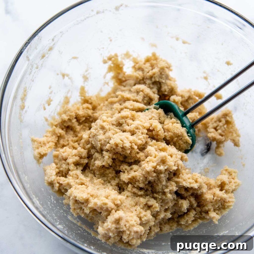 Wet almond flour pizza dough in a bowl after stirring, before resting.