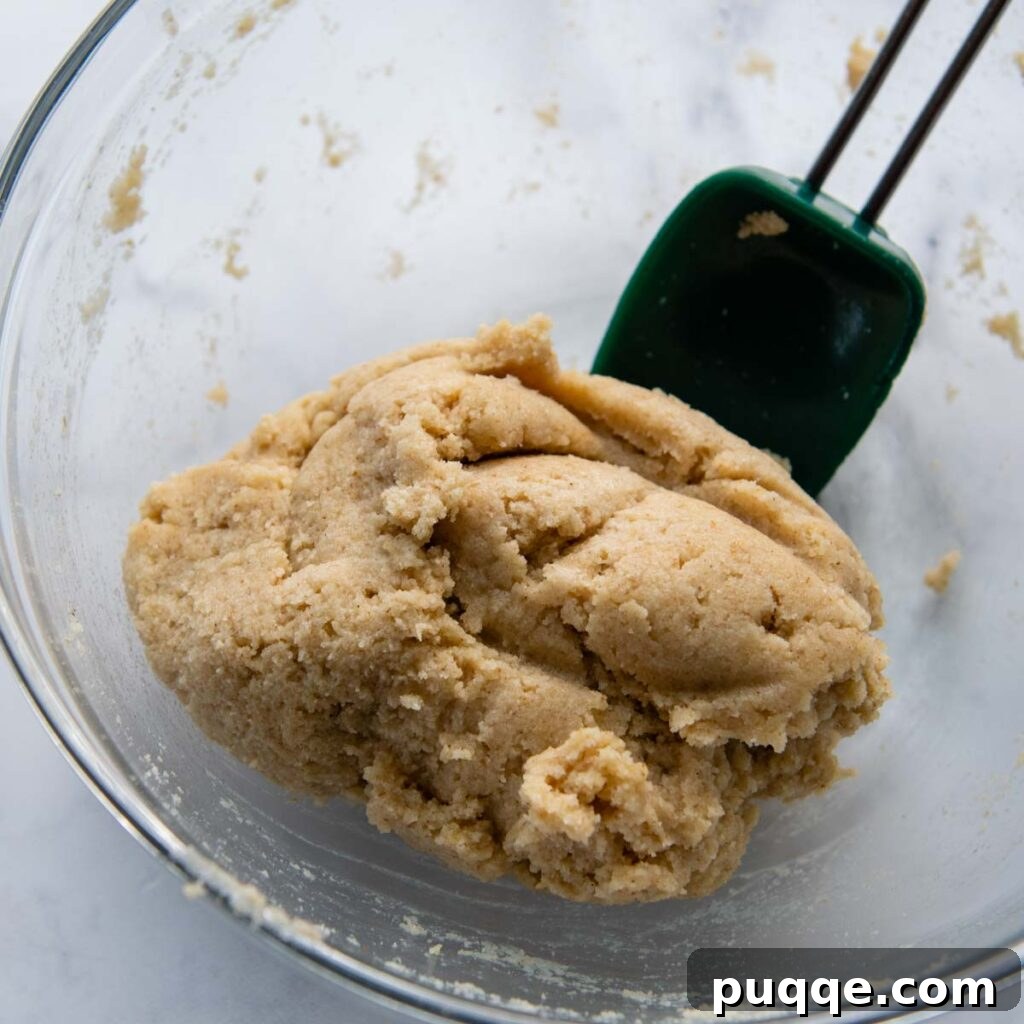Almond flour pizza dough after resting, being shaped into a ball.