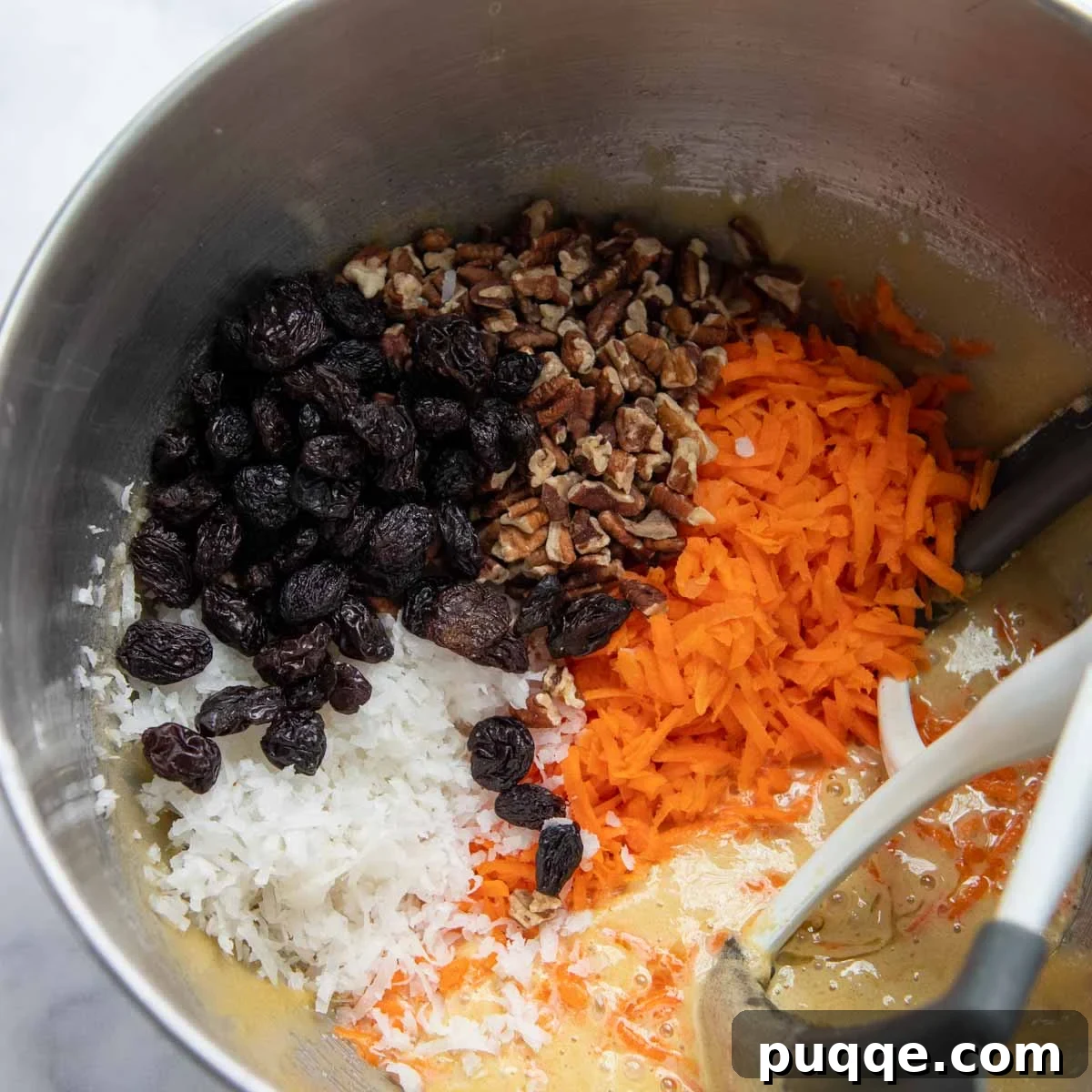 Cloud-Like Gluten-Free Almond Flour Carrot Cake 5 Thick cake batter with grated carrots, nuts, and coconut added.