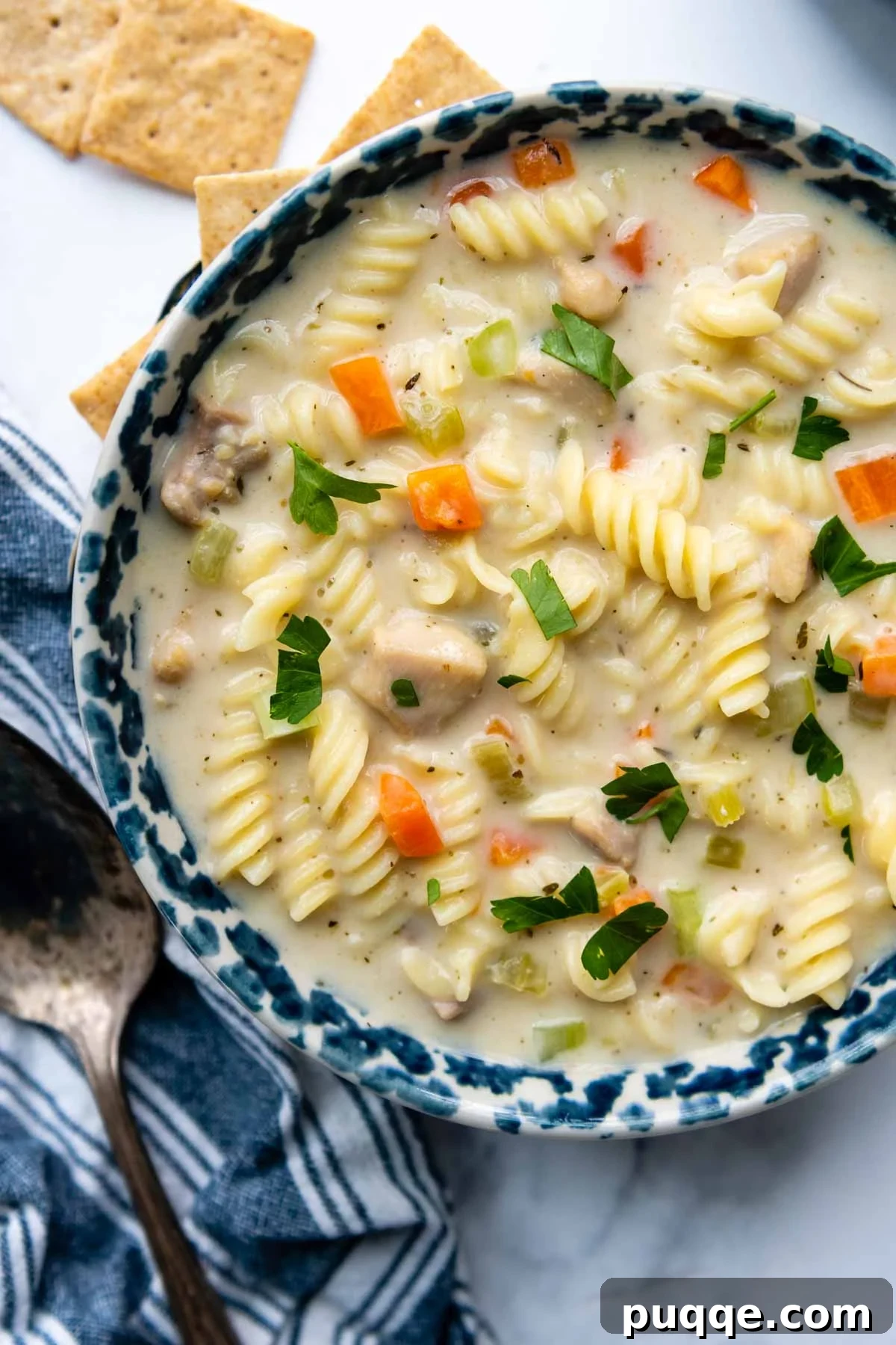 Effortlessly Flavorful Gluten-Free Chicken Noodle Soup 2 A comforting bowl of creamy gluten-free chicken noodle soup, garnished with fresh herbs, ready to be enjoyed.