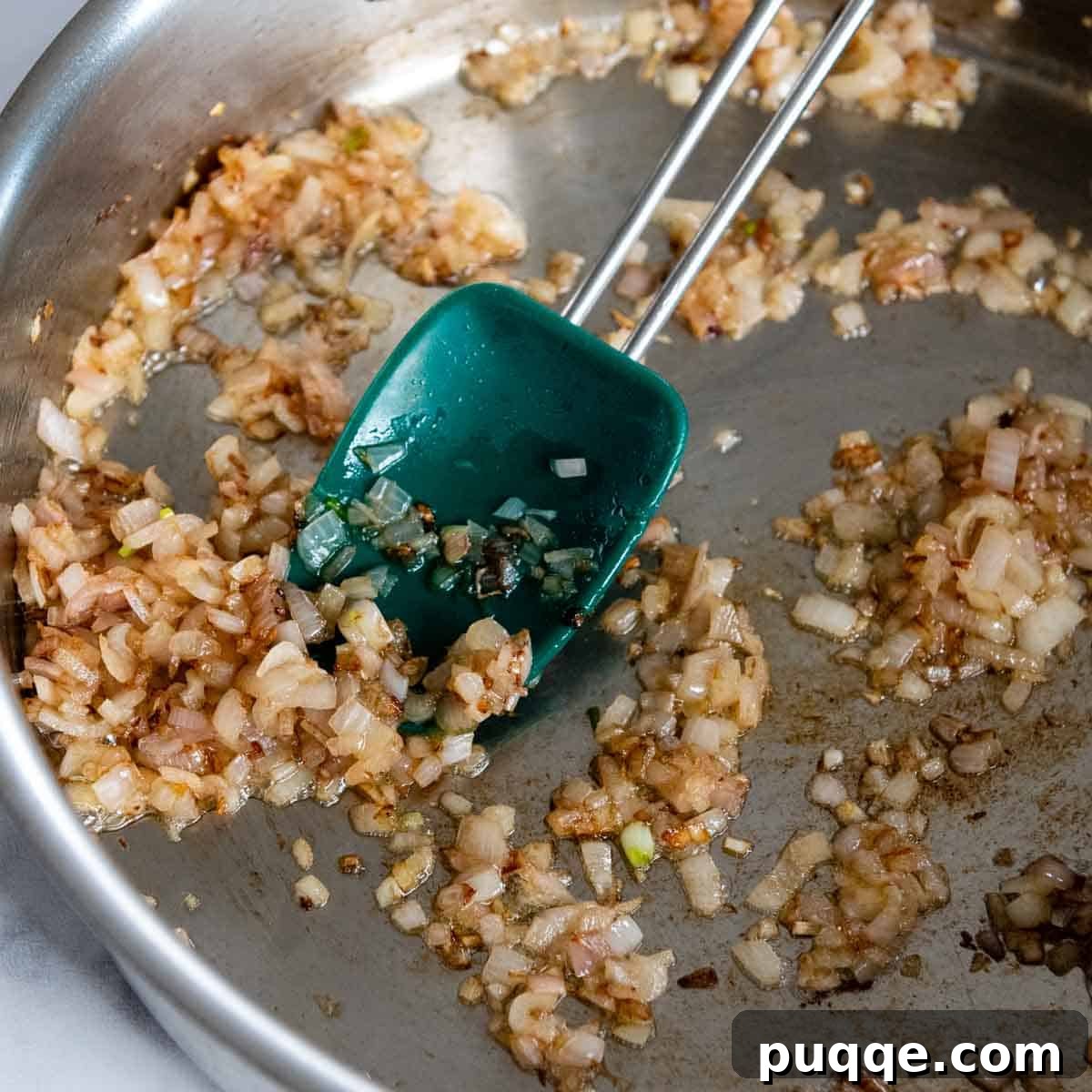 minced shallots sauteed in a pan.
