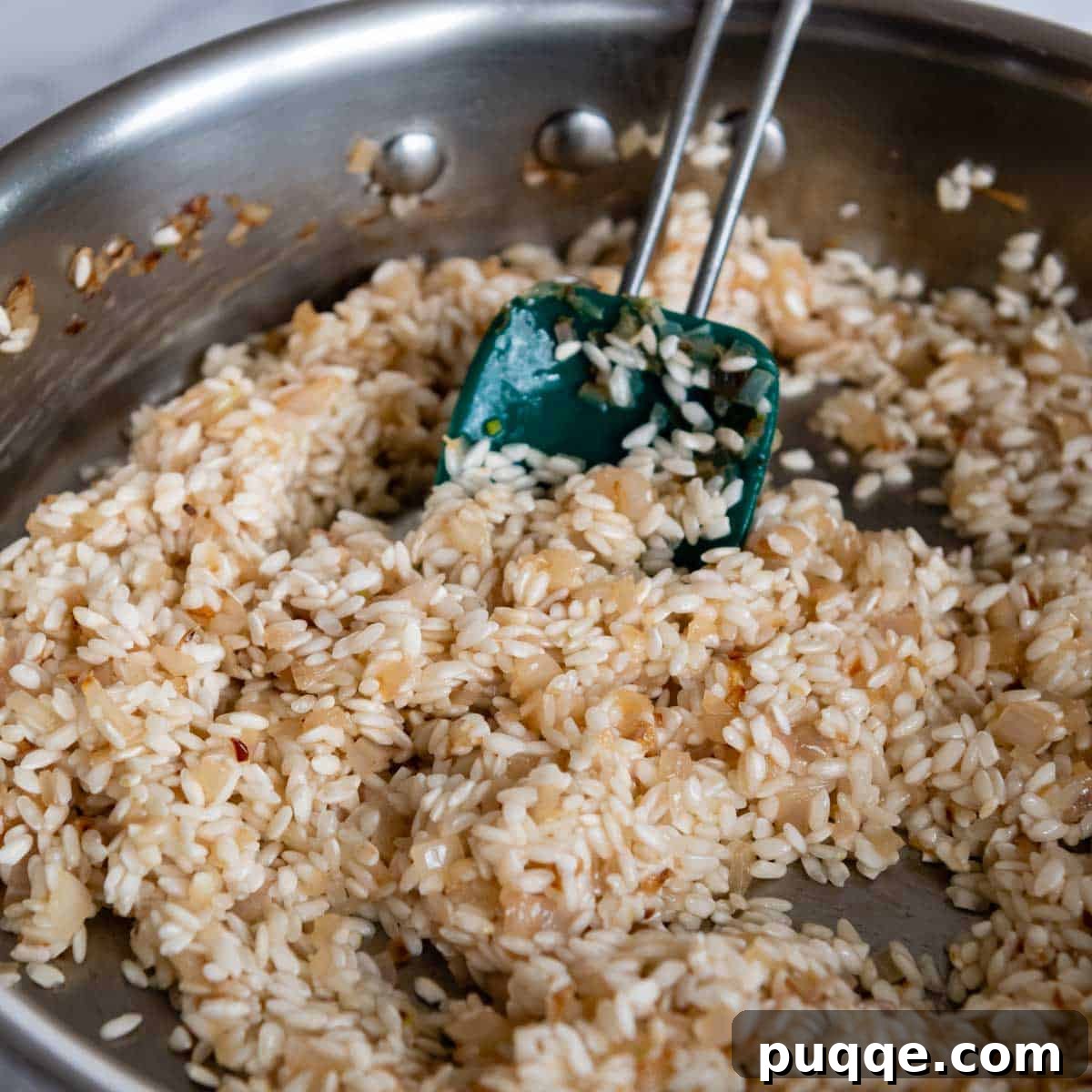 arborio rice and wine added to the pan.