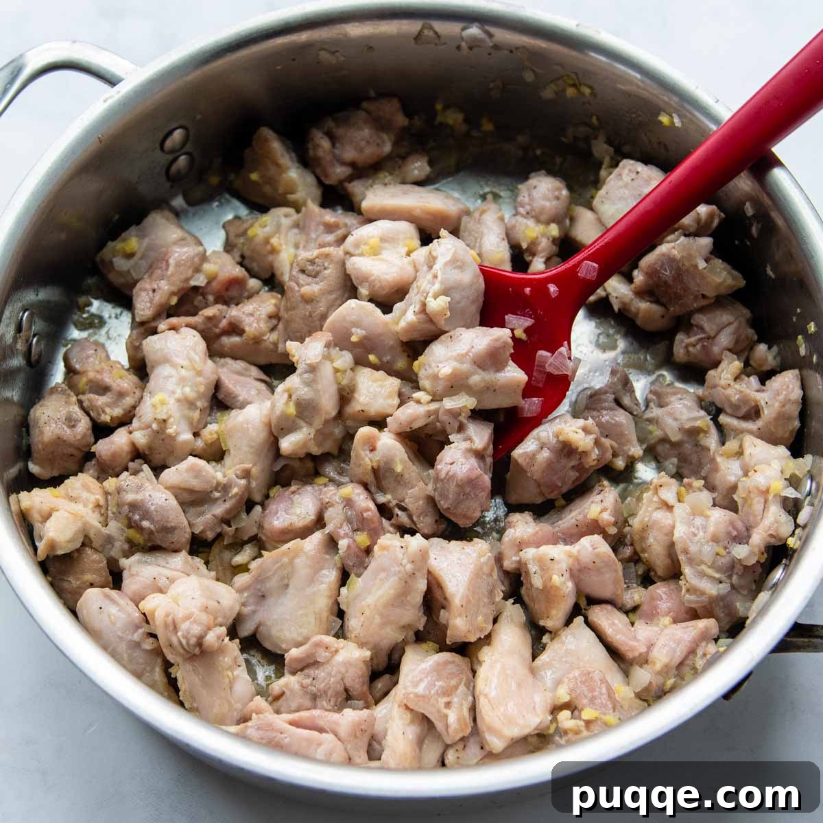Your Go-To Gluten-Free Curry: Max Flavor, Minimal Effort 3 Chicken thighs cooking in a skillet with shallots and ginger until just opaque.