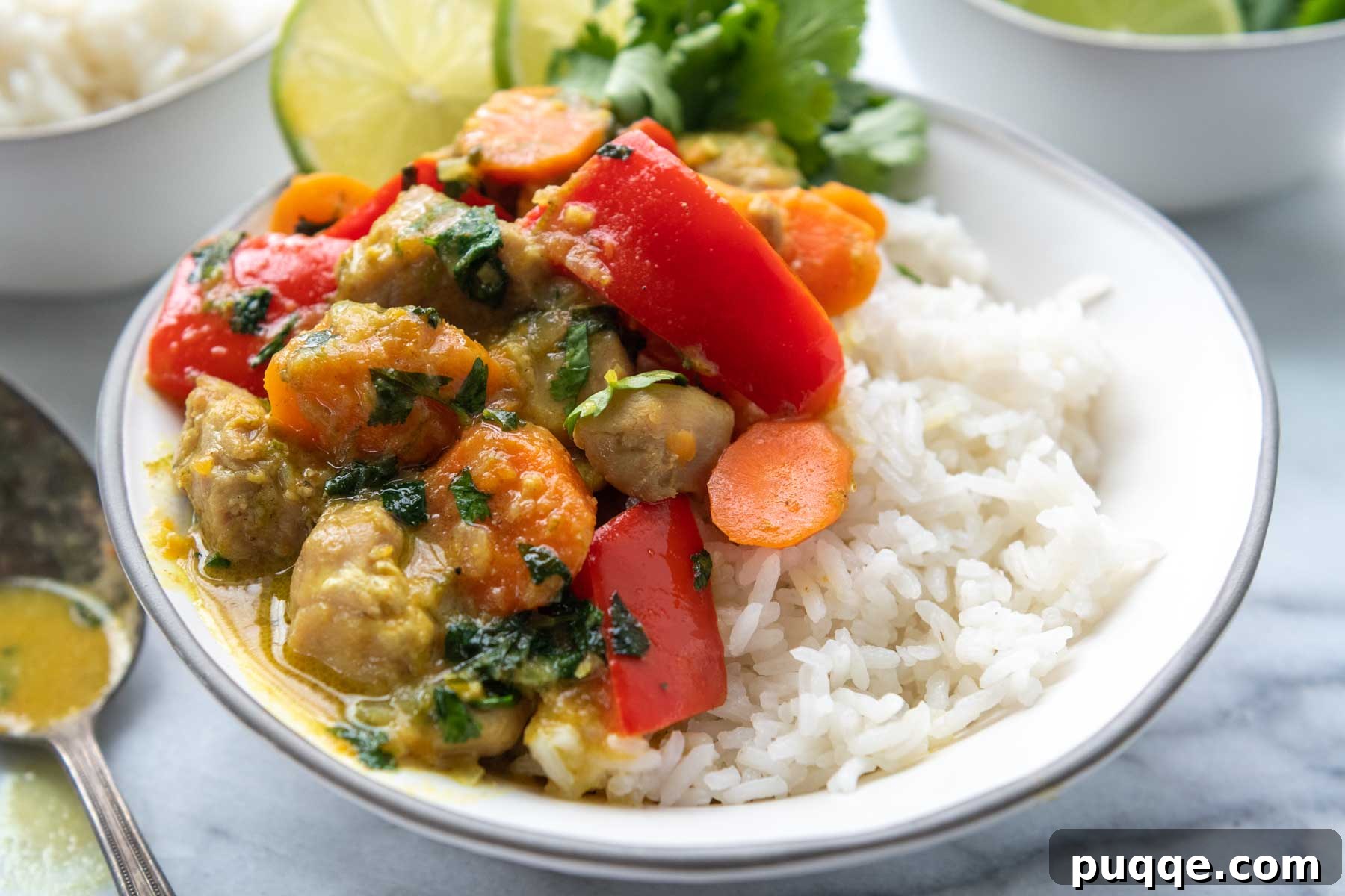 Your Go-To Gluten-Free Curry: Max Flavor, Minimal Effort 6 A beautifully presented bowl of gluten-free coconut chicken curry, garnished with lime slices and fresh cilantro.