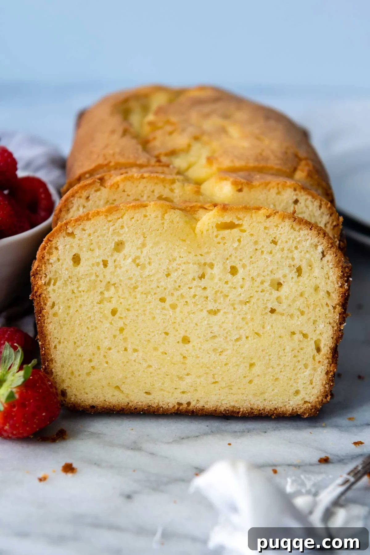 The Secret to Unbelievably Moist Gluten-Free Pound Cake 2 Delicate slices of golden gluten-free pound cake, showcasing its moist and tender crumb, arranged beautifully on a serving plate.