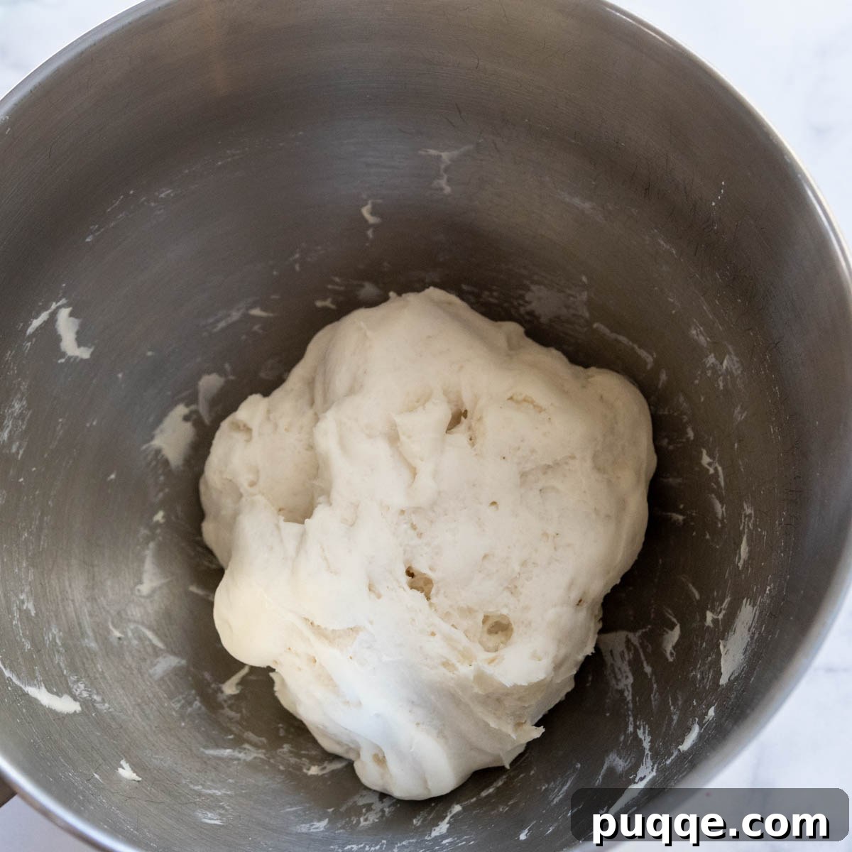 Foolproof Soft Gluten-Free Flatbread 5 Gluten-free flatbread dough in a bowl after rising, visibly expanded and lighter in texture.