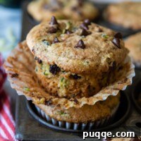 a muffin unwrapped from the liner sitting on a vintage muffin pan.