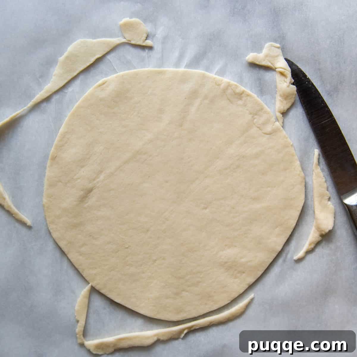 The edges of a rolled gluten-free tortilla being trimmed to create a perfectly round shape.