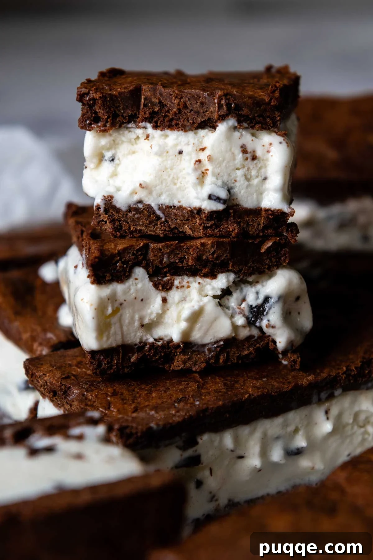 The Ultimate Gluten Free Ice Cream Sandwiches 2 A perfectly halved gluten-free ice cream sandwich, revealing its creamy filling and stacked atop another whole sandwich.