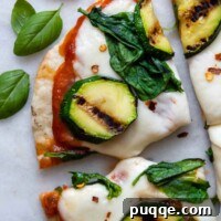 Grilling Gluten-Free Pizza: Easy Steps to Irresistible Results 9 close up of a slice of grilled pizza with basil leaves next to it.