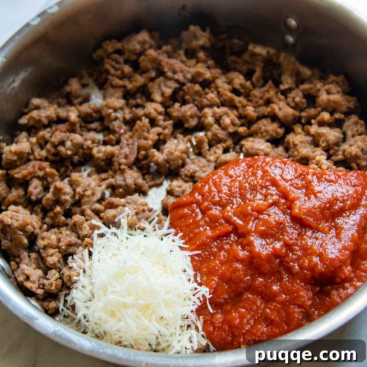 Hearty Gluten-Free Sausage-Filled Eggplant Boats 5 sausage in a skillet with marinara and parmesan.