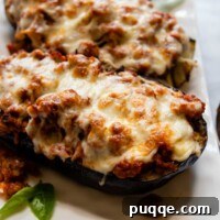 close up of baked eggplant on a white dish.