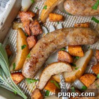 A close up overhead shot of baked Italian sausage on a baking sheet with a large serving fork underneath