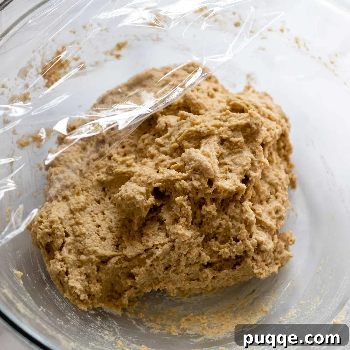Cloud-Like Gluten-Free Oat Drop Biscuits 5 oat flour biscuit dough resting in a bowl, covered with plastic wrap.