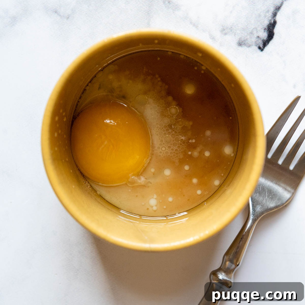 Effortless Gooey Fudgy Gluten-Free Mug Brownie 3 liquid ingredients with a fork resting nearby.