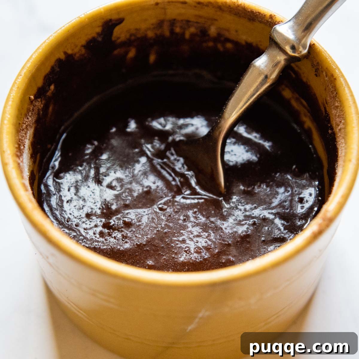 Effortless Gooey Fudgy Gluten-Free Mug Brownie 4 a fork mixing the brownie batter.