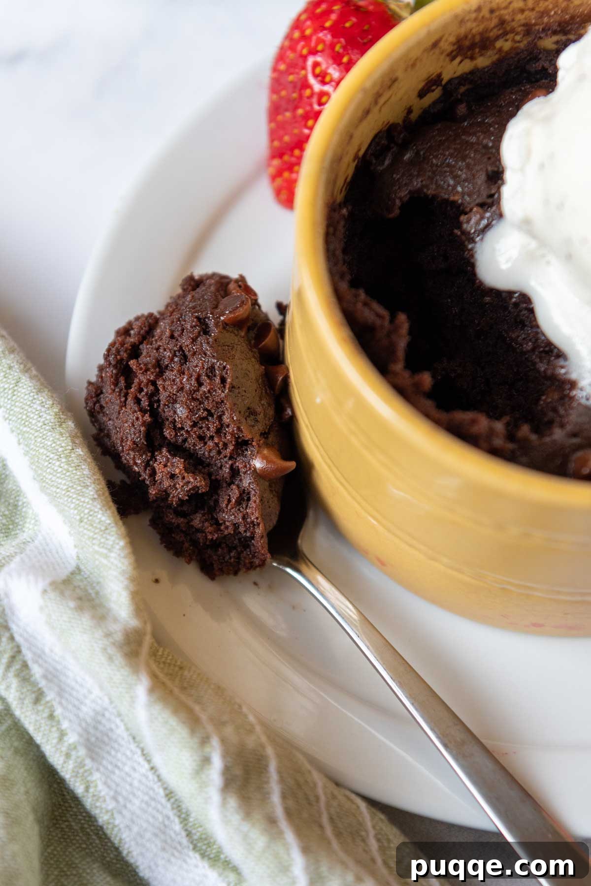 Effortless Gooey Fudgy Gluten-Free Mug Brownie 8 a spoon of brownie resting on a dish.