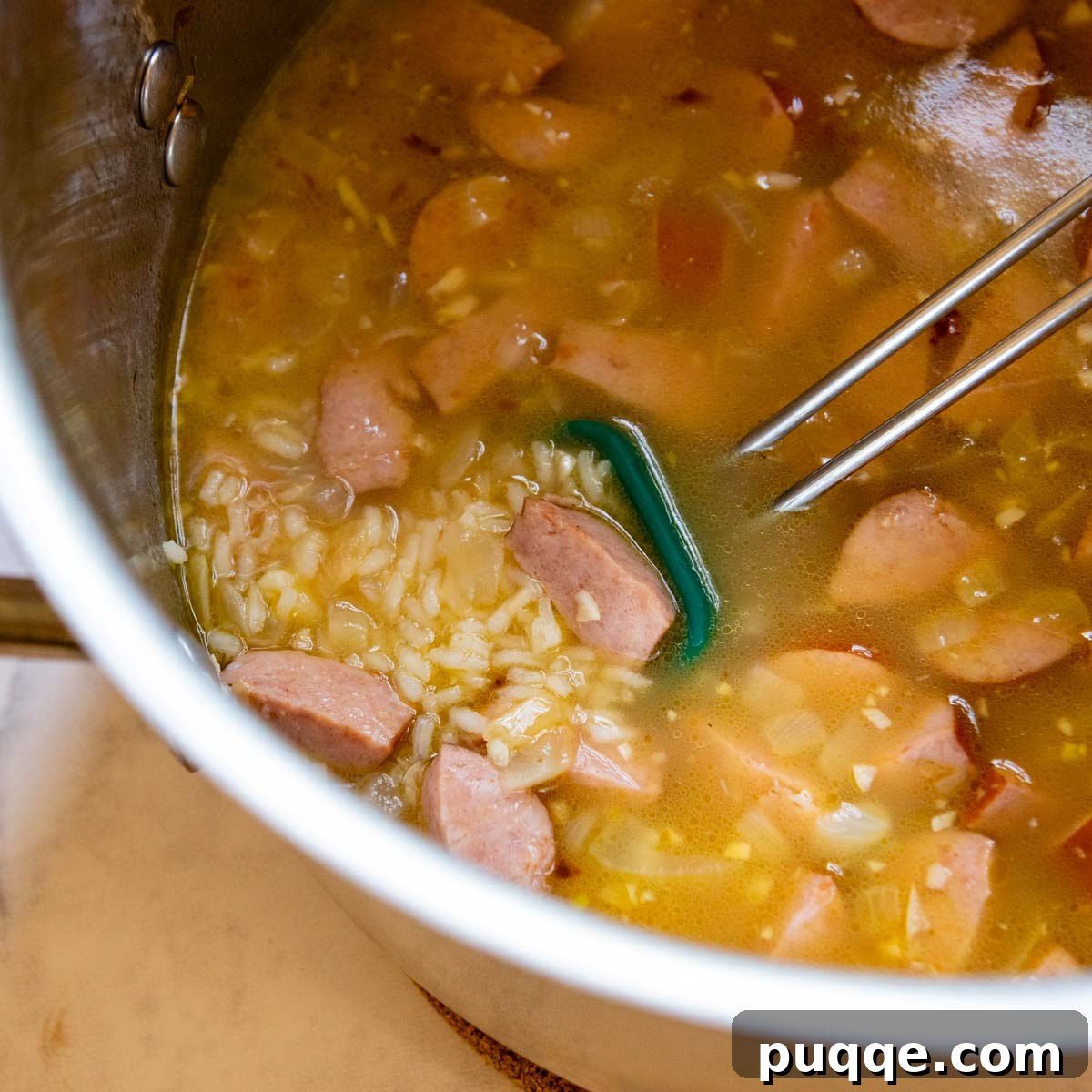 Broth and rice added to the soup pot.