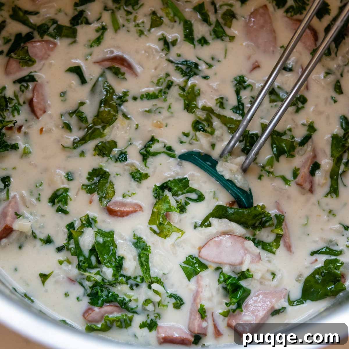 Heavy cream being stirred into the finished soup.