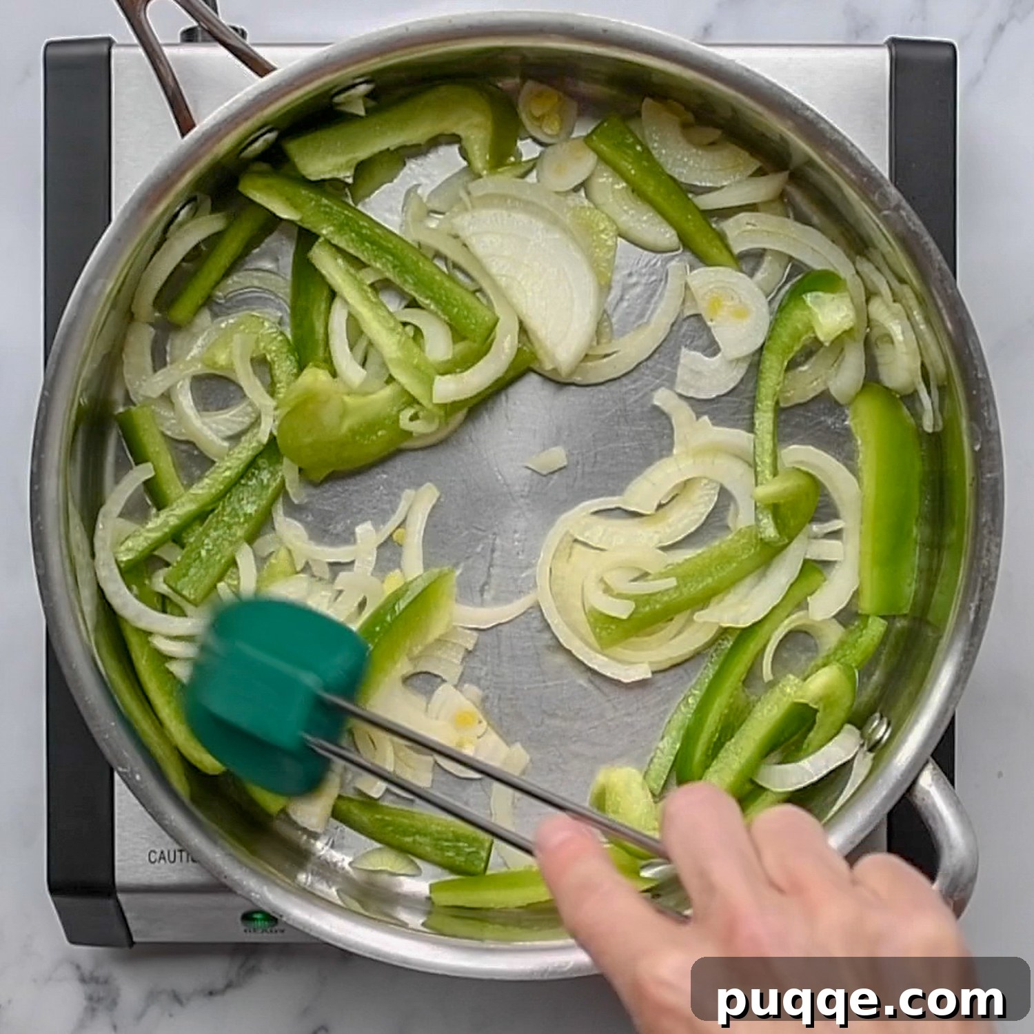 Quick Skillet Mexican Fish Dinner 3 Sliced bell peppers and onions sautéing in a skillet with olive oil.