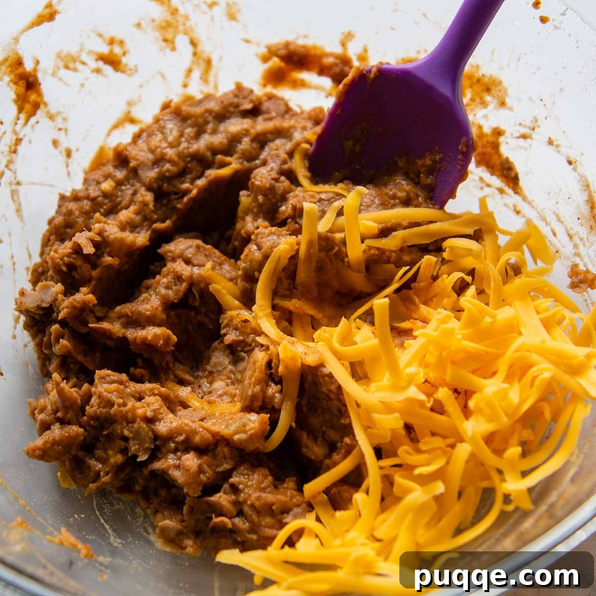 10-Minute Gluten-Free Cheesy Crunchwrap Quesadillas 4 freshly grated cheese being stirred into the bean mixture.