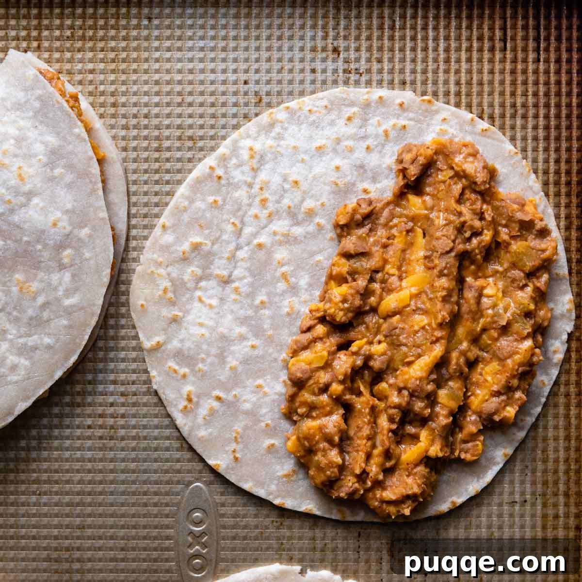 10-Minute Gluten-Free Cheesy Crunchwrap Quesadillas 5 half of a tortilla spread with the bean mixture, ready to be folded.