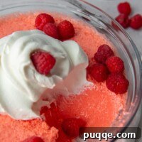 A scoop of creamy Jello salad taken out of a serving bowl, ready to be enjoyed.