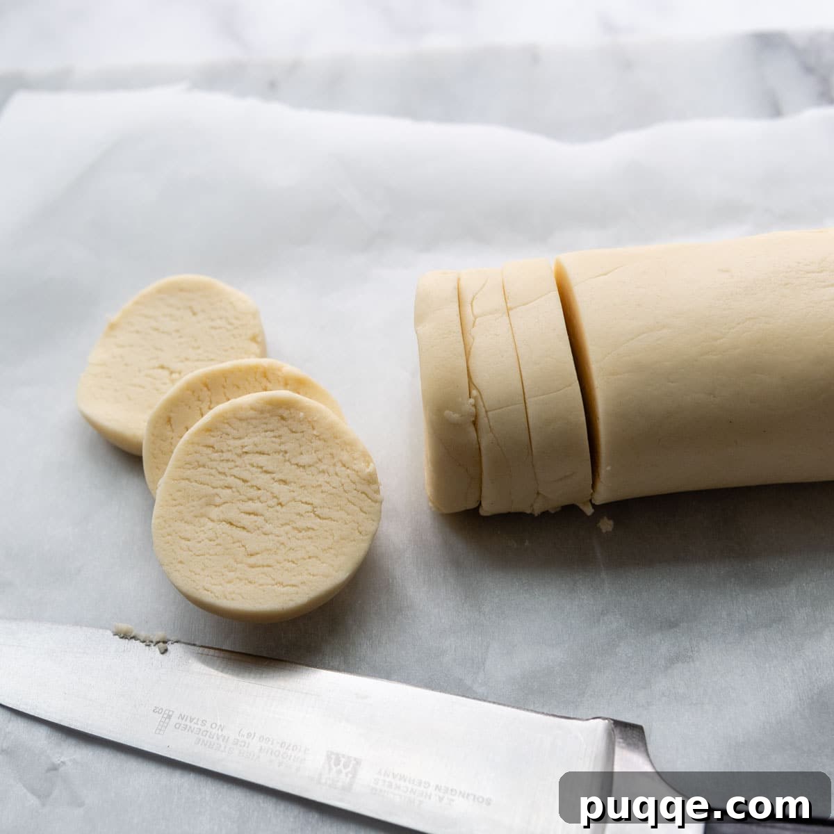 a log of cookie dough with sliced rounds.