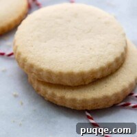 side view of two stack cookies on a marble surface.