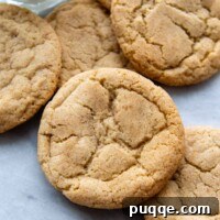 Gluten-free snickerdoodles arranged on a marble surface with a glass of milk.