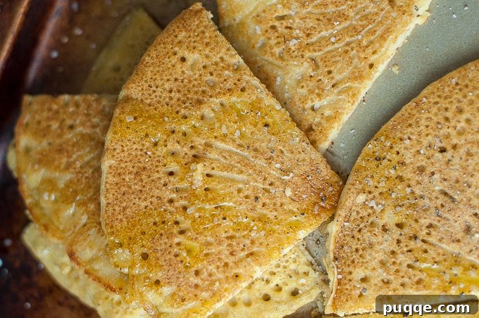 Your Go-To 5-Ingredient Socca Flatbread 6 socca cut in wedges and drizzled with olive oil, salt, and pepper