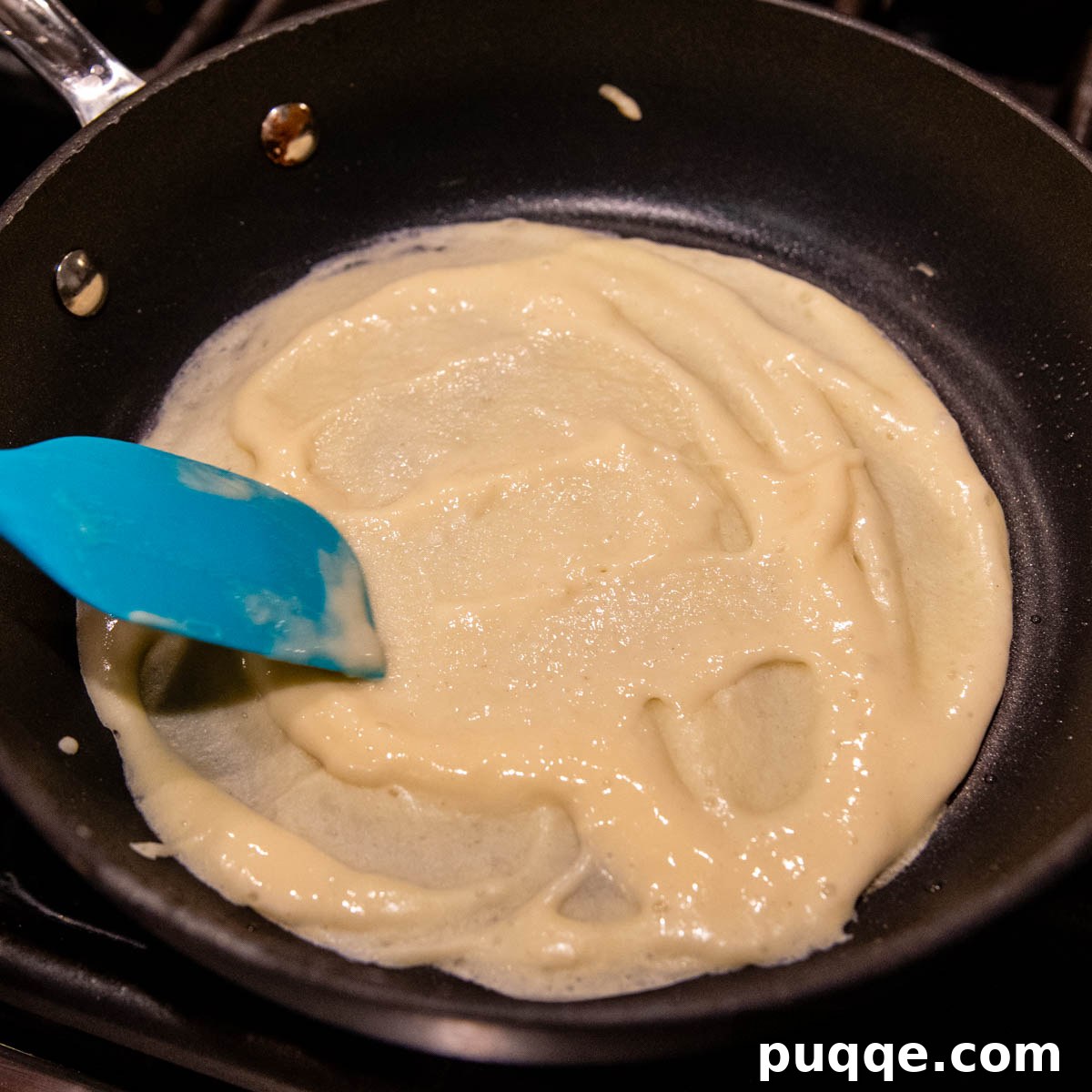 Effortless Homemade Gluten-Free Manicotti with Tender Crepe Shells 4 the crepe batter being spread in a small nonstick skillet.
