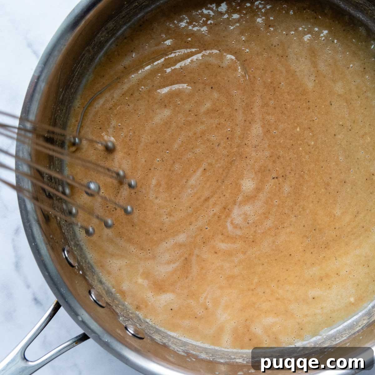 Effortless Oven Baked Gluten-Free Swedish Meatballs 6 Butter and gluten-free flour being whisked together in a skillet to form a roux.
