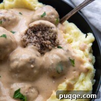 Swedish meatball broke open in a bowl of mashed potatoes.