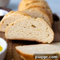 Slices of delicious gluten-free Italian bread on a wooden cutting board.
