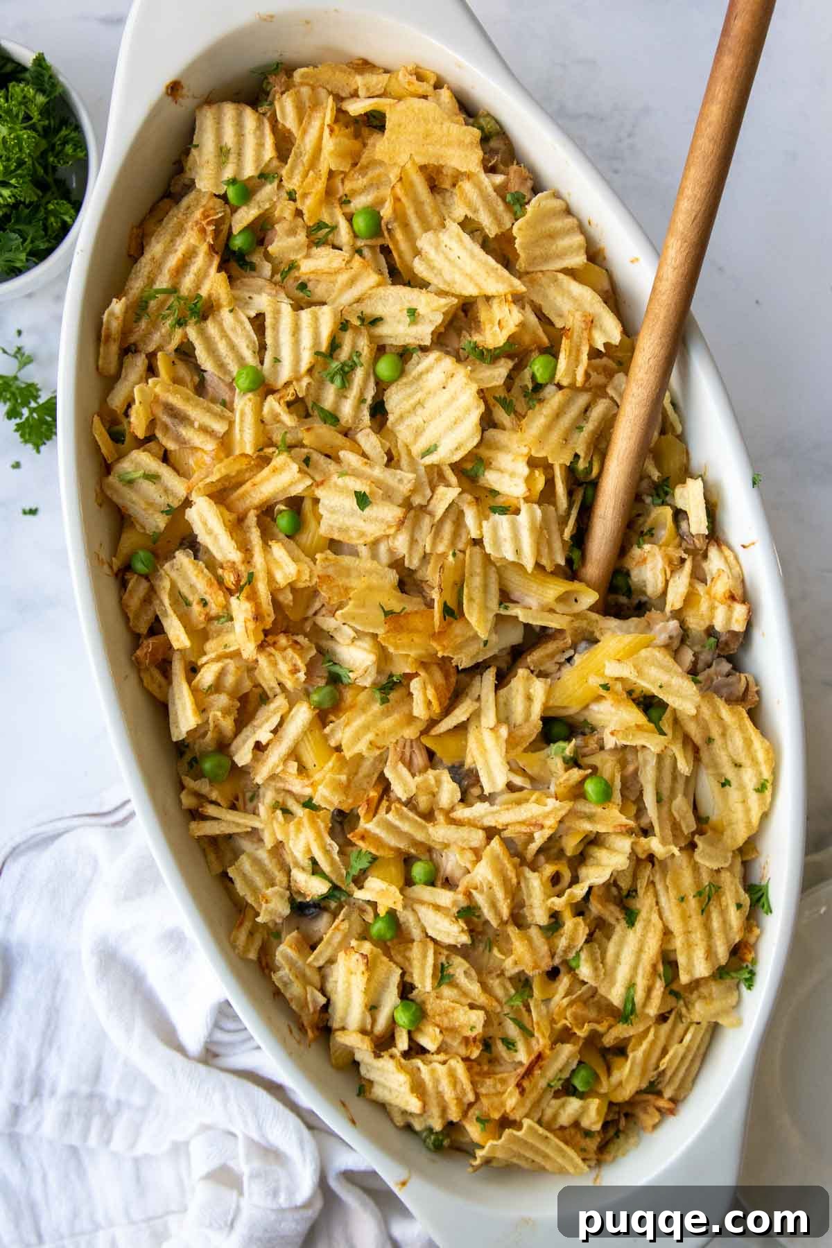 Wholesome Gluten-Free Tuna Noodle Casserole 2 overhead shot of tuna casserole with a wooden spoon going into it