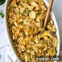 Wholesome Gluten-Free Tuna Noodle Casserole 8 overhead shot of tuna casserole with a wooden spoon going into it