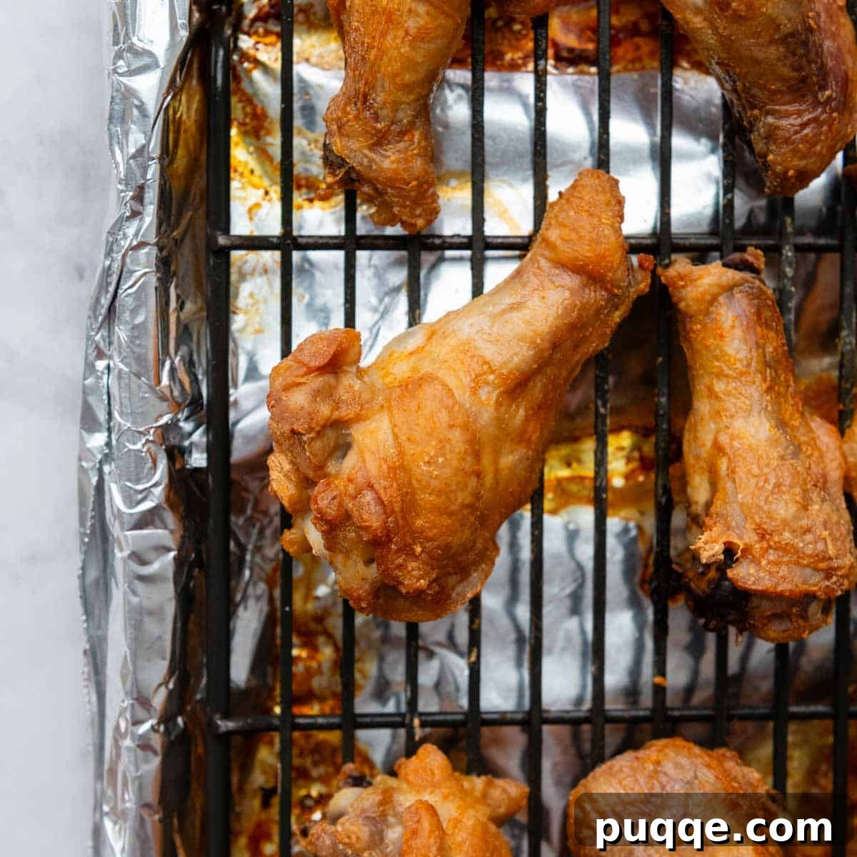 A single perfectly baked, golden-brown chicken wing, showcasing its crispy skin texture.