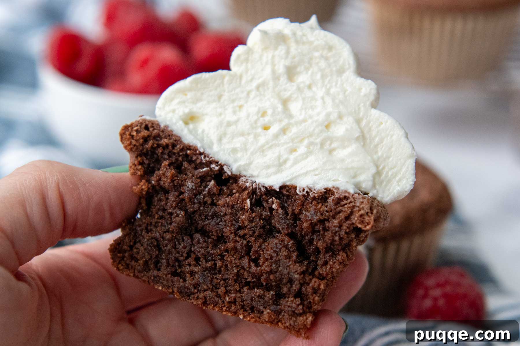 Pillowy Chocolate Almond Flour Cupcakes Gluten Free 11 Two frosted chocolate almond flour cupcakes, one with raspberries.