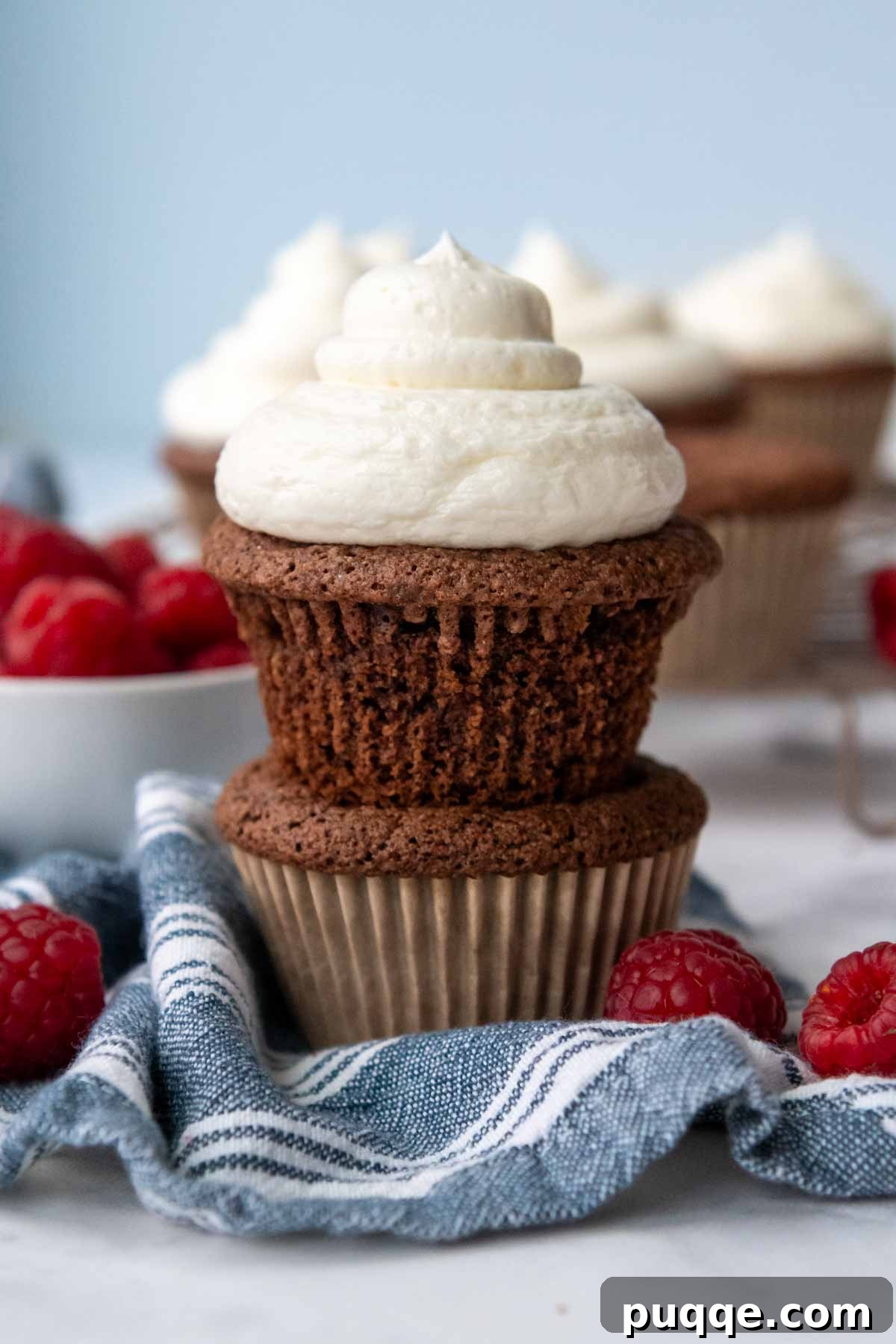 Pillowy Chocolate Almond Flour Cupcakes Gluten Free 12 an unwrapped cupcake on top of an unfrosted one.