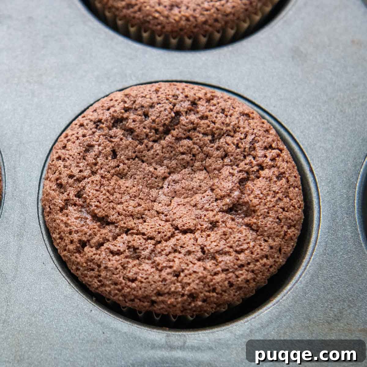 Pillowy Chocolate Almond Flour Cupcakes Gluten Free 3 a baked cupcake in a muffin tin.