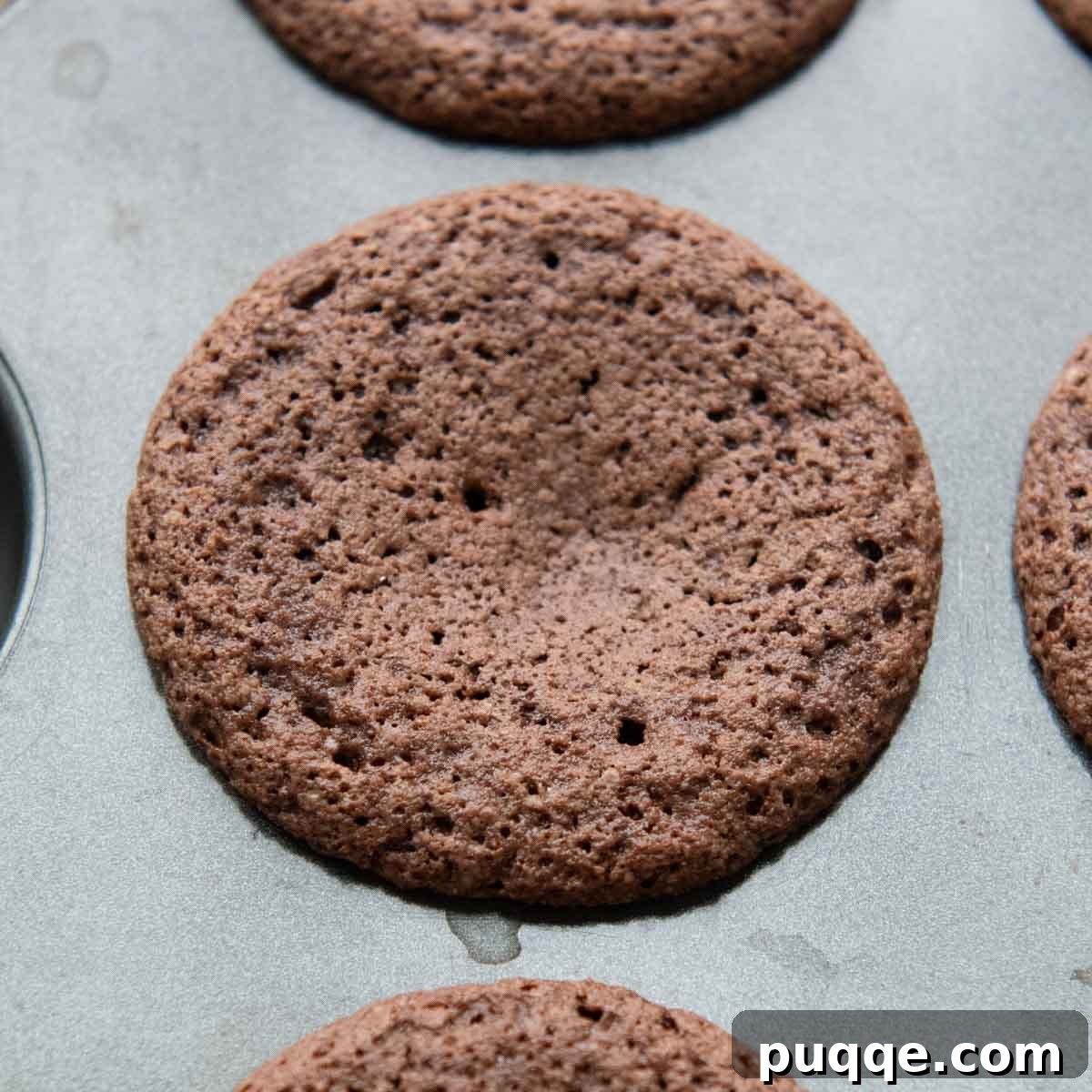 Pillowy Chocolate Almond Flour Cupcakes Gluten Free 4 a cupcake in a muffin tin.