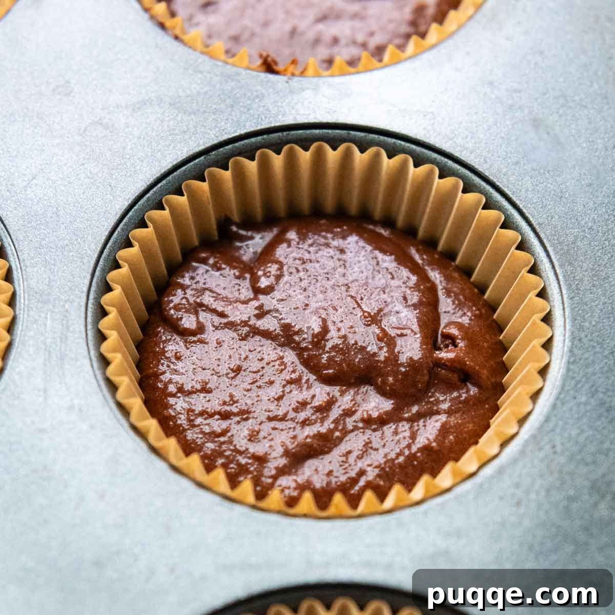 Pillowy Chocolate Almond Flour Cupcakes Gluten Free 9 unbaked cupcake batter in a tin.