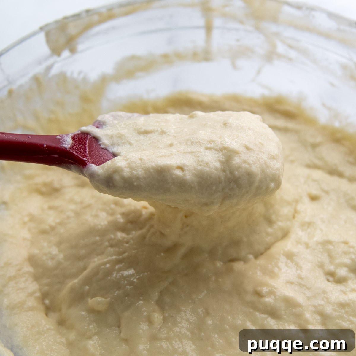A close-up shot of a very thick pancake batter in a mixing bowl, illustrating the unmanageable consistency caused by certain gluten-free flour blends with high cornstarch content.